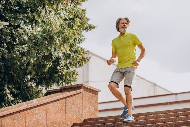 Free photo middle aged man jogging down and upstairs