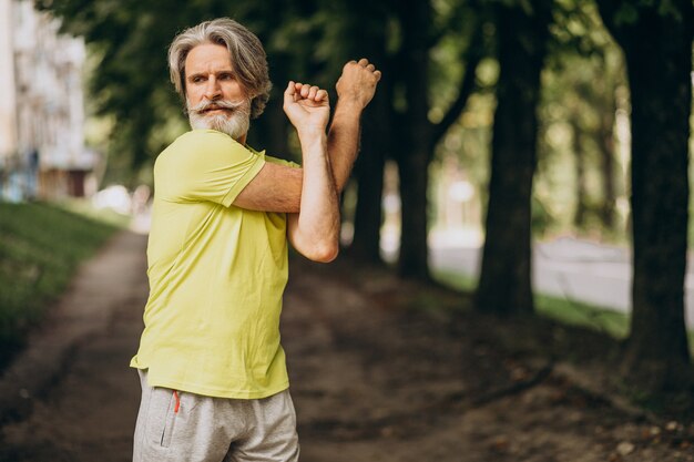 Middle aged man jogging in forest