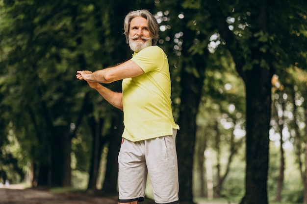 Middle aged man jogging in forest