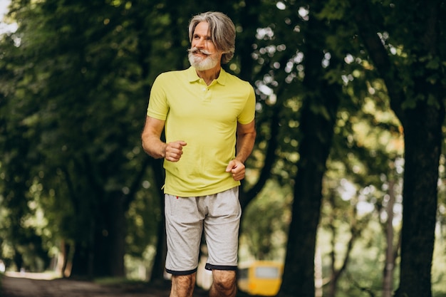 Middle aged man jogging in forest