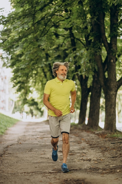 Middle aged man jogging in forest