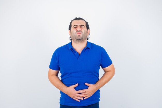 Free photo middle aged man suffering from stomach pain