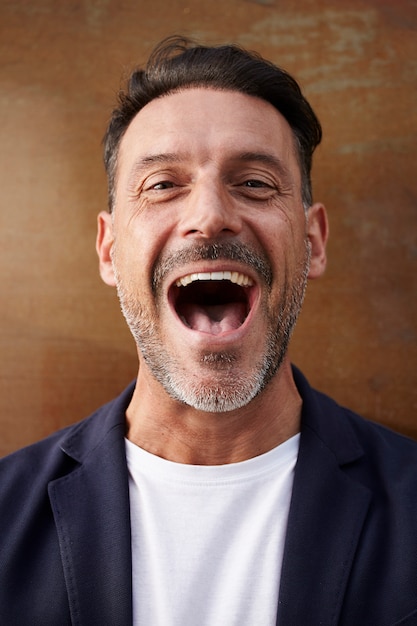 Free photo middle-aged man wearing a jacket laughing happy