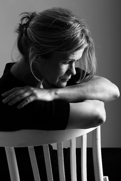 Middle aged woman on a chair