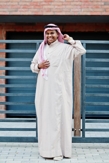 Middle Eastern arab man posed on street against modern building