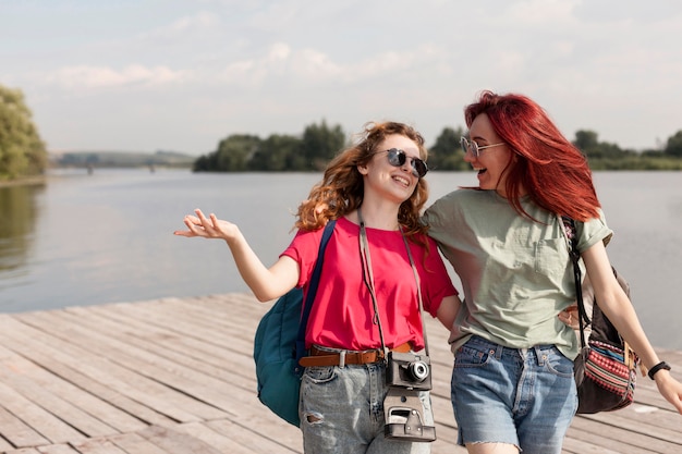 Middle shot women smiling on dock