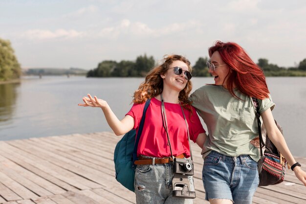 Middle shot women smiling on dock