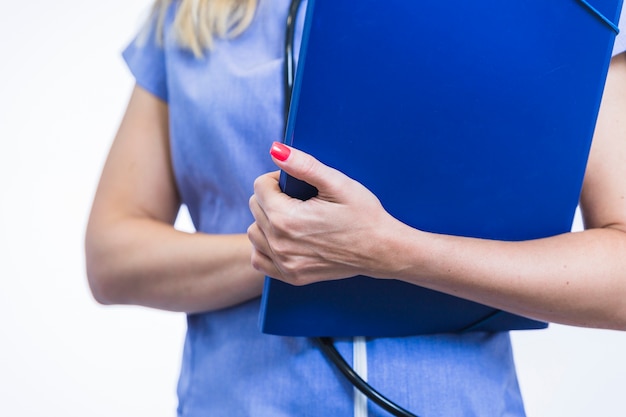 Midsection view of a female dentist's hand holding folder