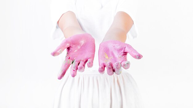 Midsection view of a woman's messy hand with paint