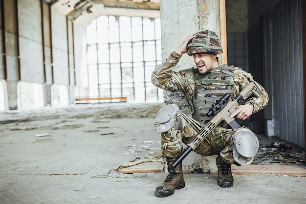 Military in the form holds in the hands of a big rifle