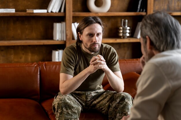 Military man suffering from ptsd having psychologist session