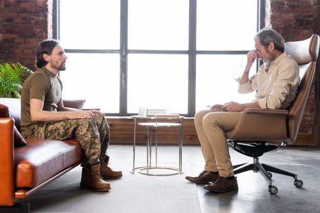 Military man suffering from ptsd having psychologist session
