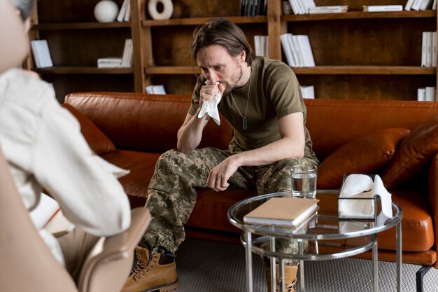 Military man suffering from ptsd having psychologist session
