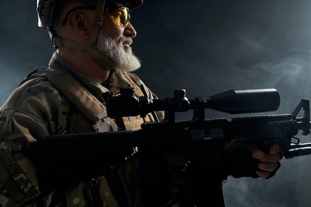 Military veteran holding sniper rifle