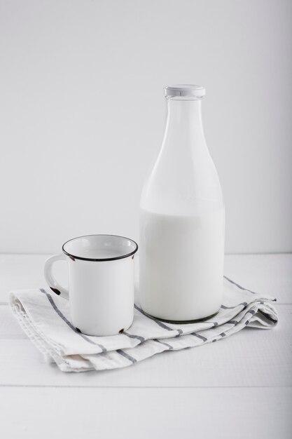 Milk in bottle near cup