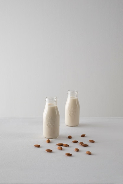 Milk bottles and almonds arrangement high angle