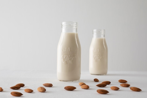 Free photo milk bottles and almonds arrangement