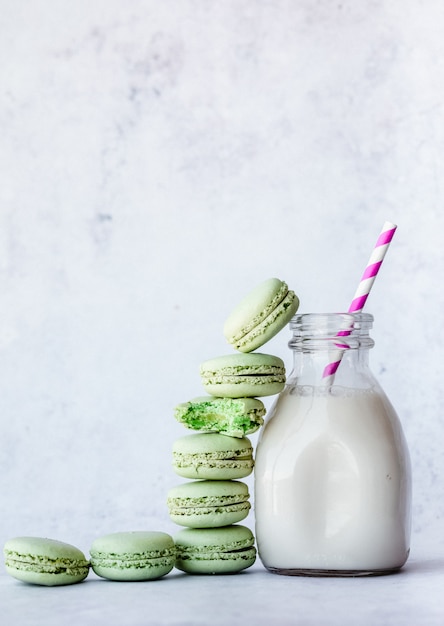 Milk in clear glass jar and macaroons