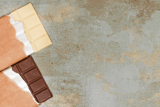 Milk and dark chocolate bar on grunge background