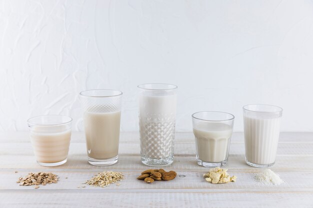 Milk in different types of glasses and cereals