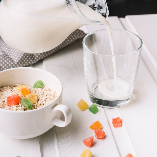 Milk is poured into the glass with oatmeal