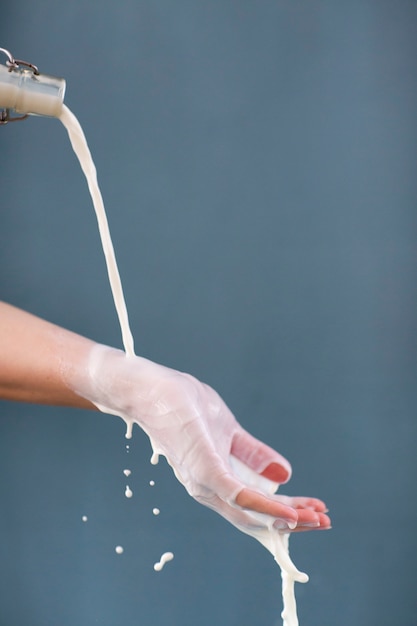 Milk pourred over hand