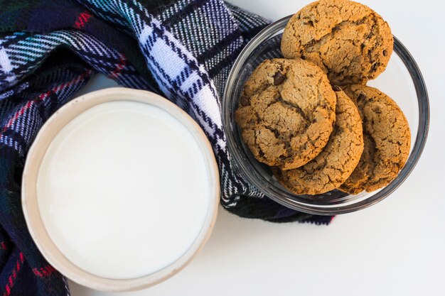 Free photo milk with cookies on checkered soft plaid