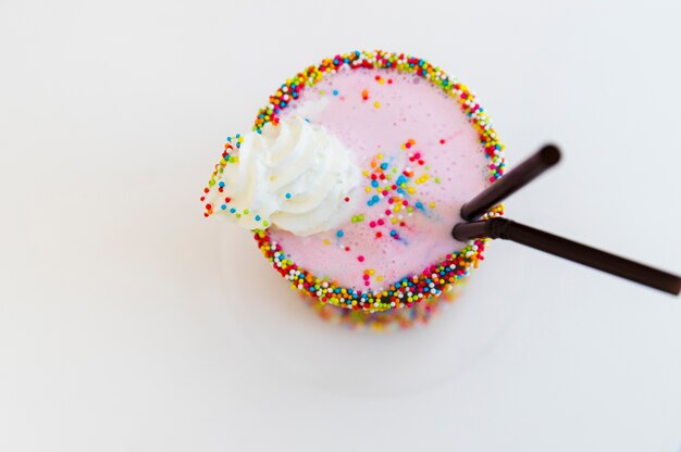Milkshake decorated with sprinkle and whipped cream