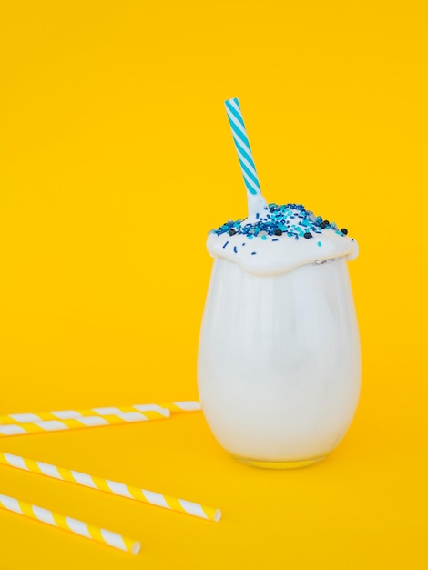 Free photo milkshake glass on yellow background