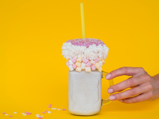 Free photo milkshake jar with yellow background