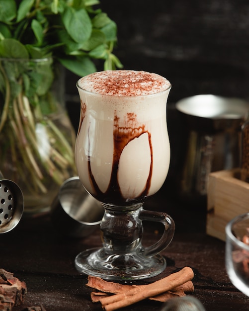 Free photo milky cocktail with chocolate syrup and cocoa powder.