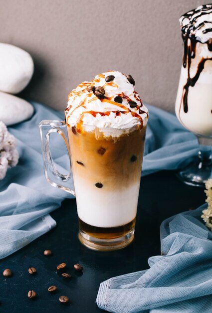 Milky frappuccino with whipping cream and chocolate chips on the top.