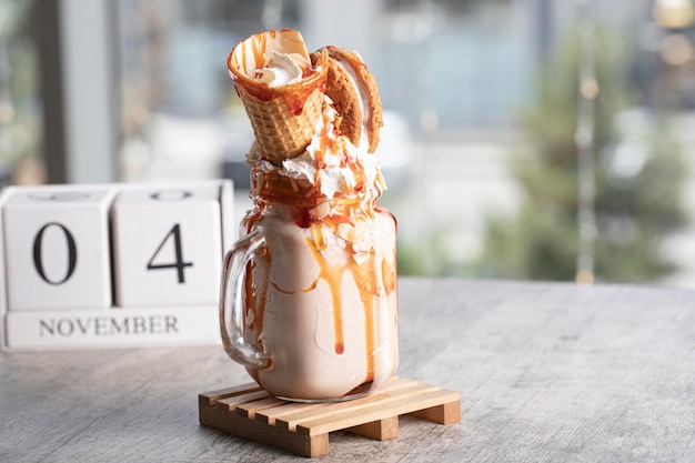 Free photo milky summer cocktail with waffle and mapple syrup