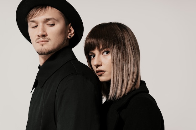 Millennial fashion couple on a white in studio