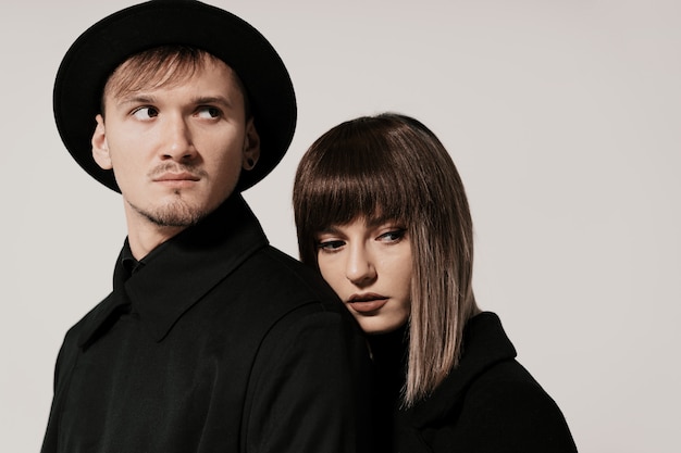 Millennial fashion couple on a white in studio