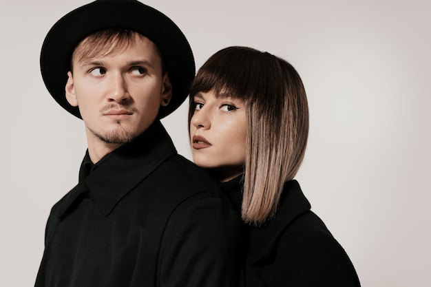 Millennial fashion couple on a white in studio