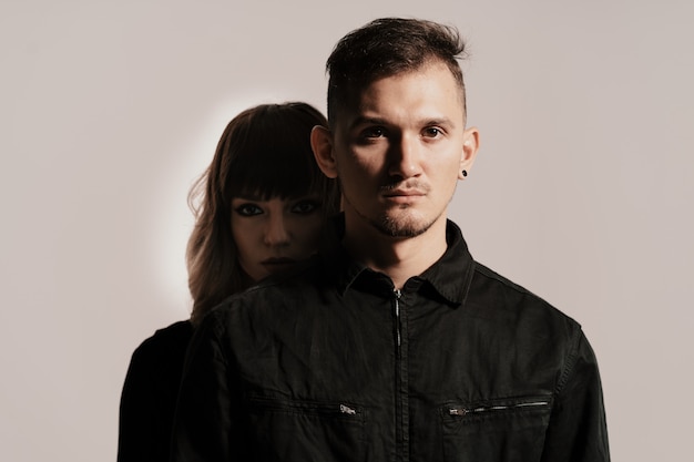 Millennial fashion couple on a white in studio