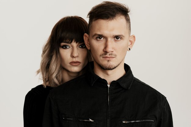 Millennial fashion couple on a white in studio