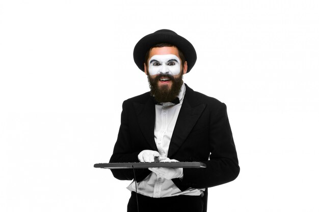 Mime as a businessman holdinga keyboard