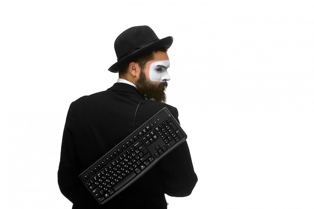 Free photo mime as a businessman holdinga keyboard behind