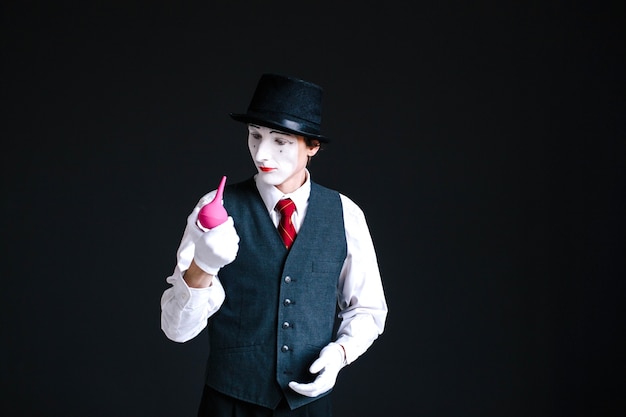 Mime holds clyster in his fingers