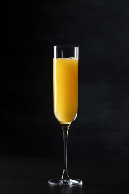 Mimosa cocktail glass with dark background