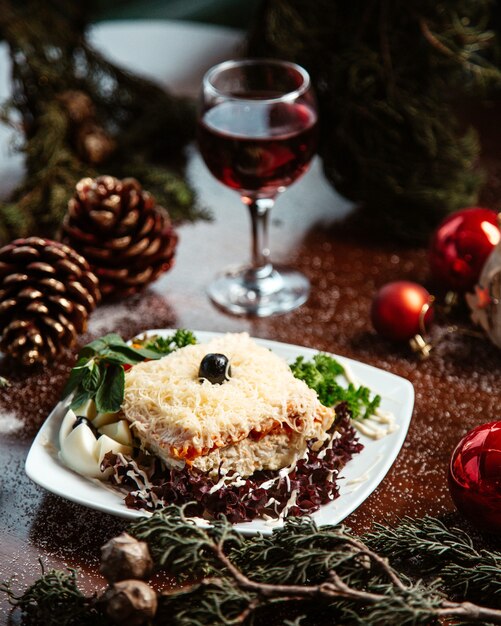 Mimosa salad with herbs and olive on top