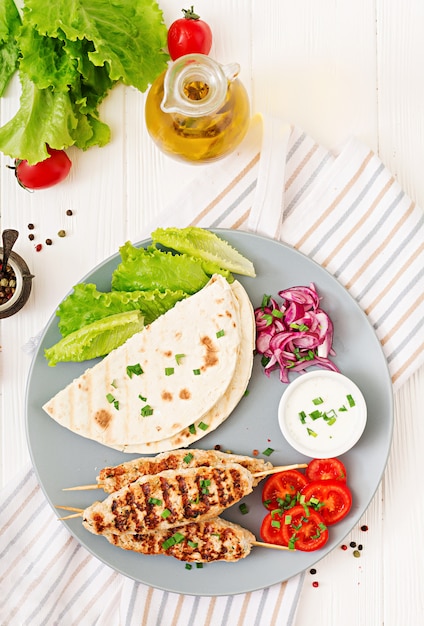 Minced Lula kebab grilled turkey (chicken) with fresh vegetables. Top view