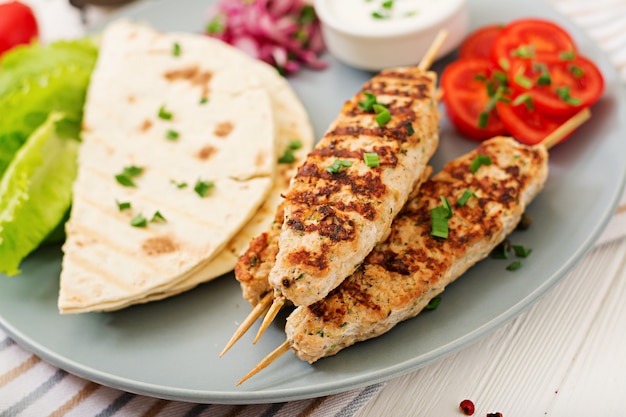 Minced Lula kebab grilled turkey (chicken) with fresh vegetables.