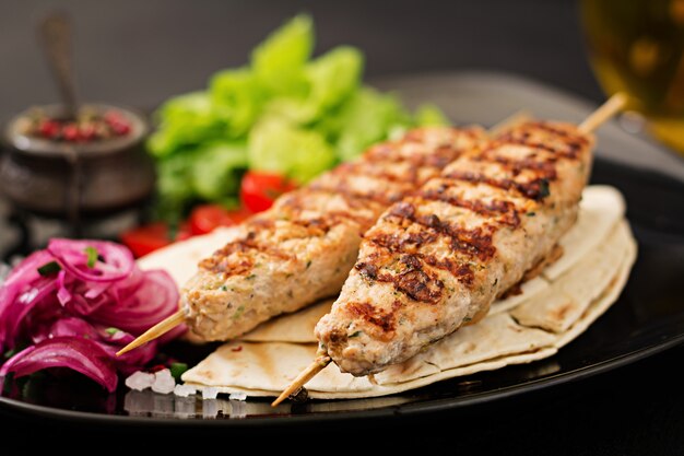 Minced Lula kebab grilled turkey (chicken) with fresh vegetables.