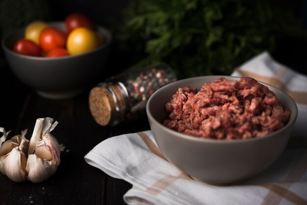 Minced meat in bowl with ingredients