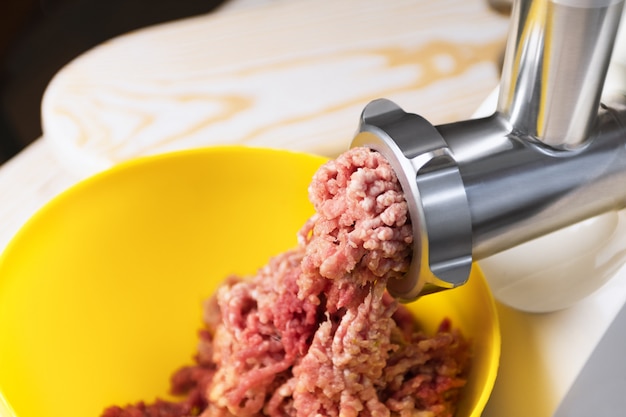 Minced meat in an electric meat grinder