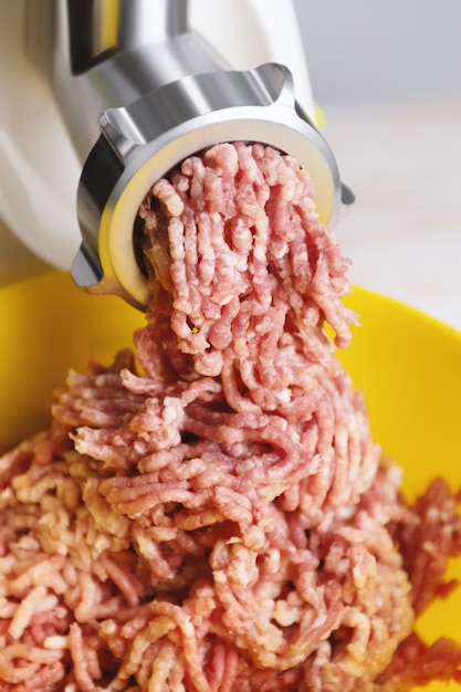 Minced meat in an electric meat grinder