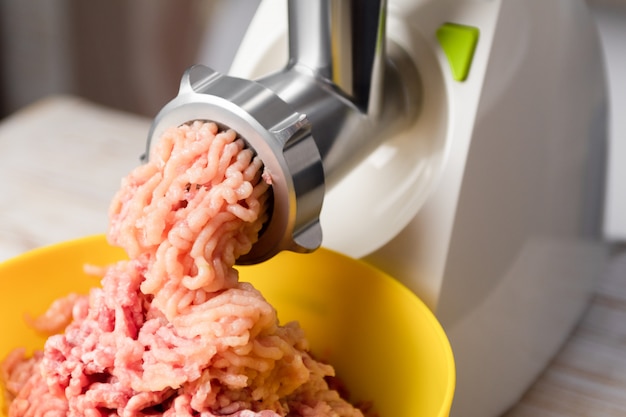 Minced meat in an electric meat grinder